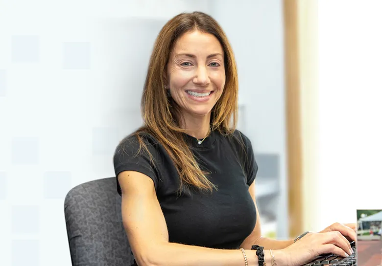 Smiling allergist at her desk in the Warren Allergy & Asthma Care office